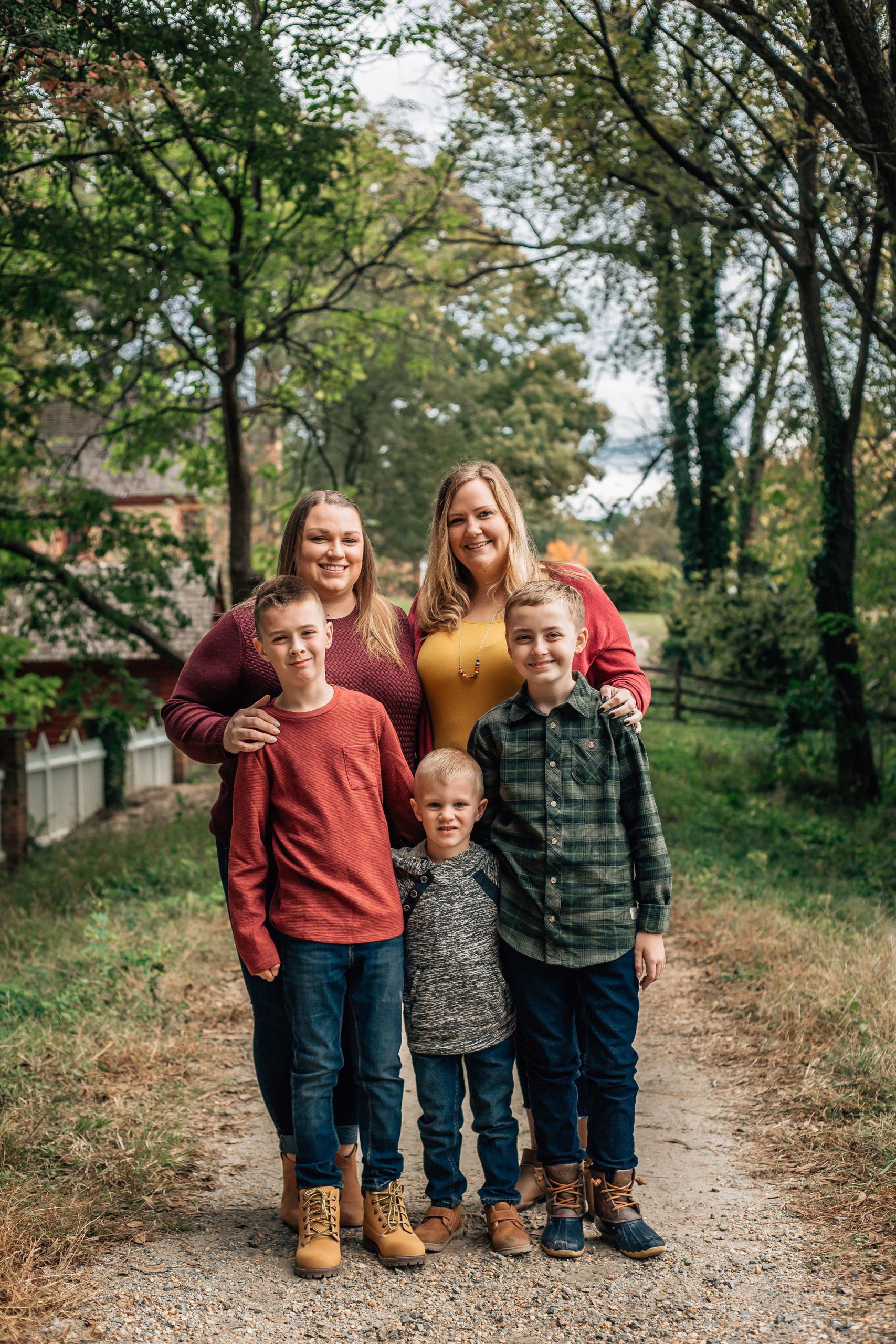 Hampton Roads family portraits of moms and their children standing on a dirt path during the fall