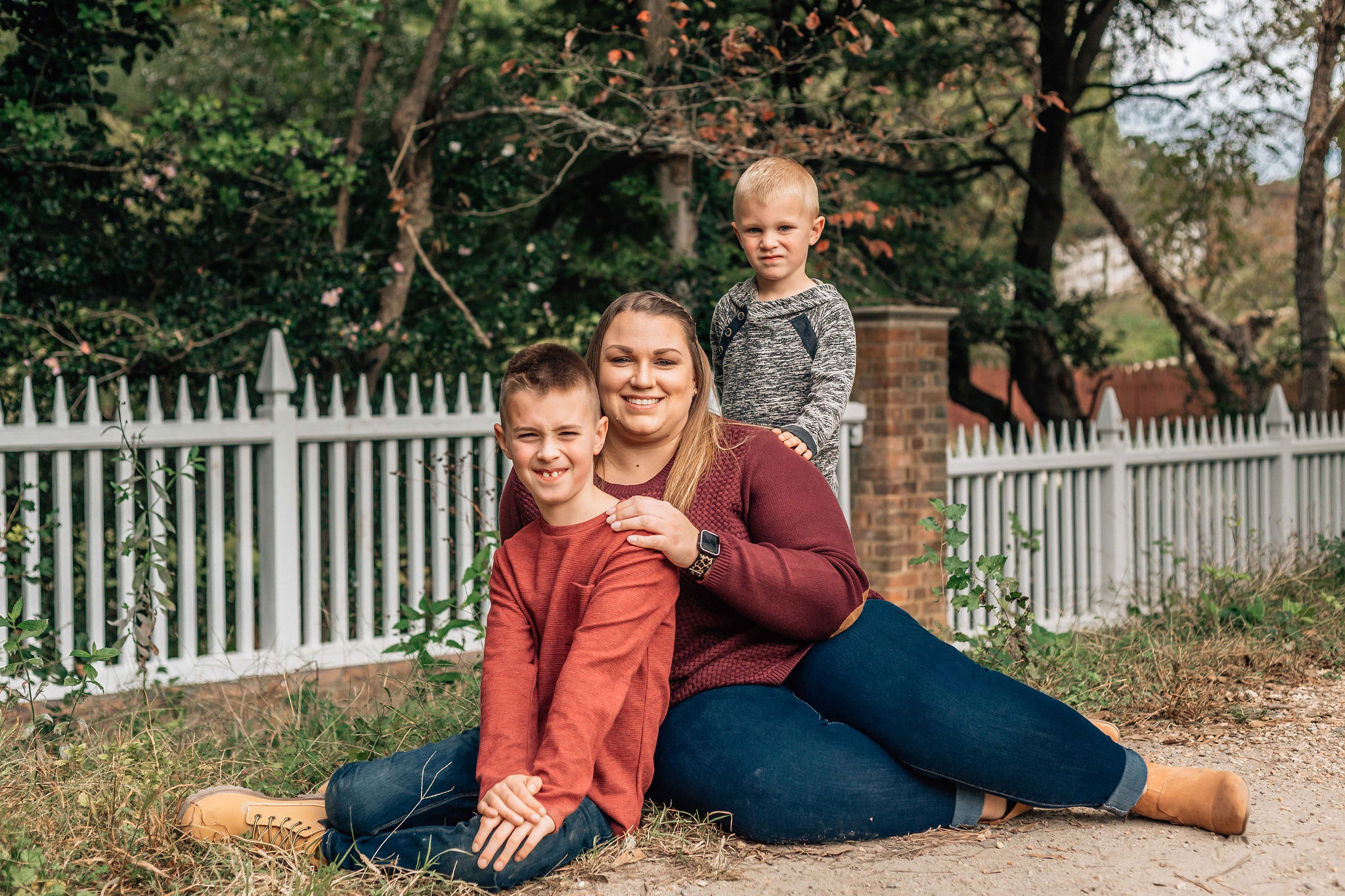 mom sitting on the ground with her two sons for their Hampton Roads family photos