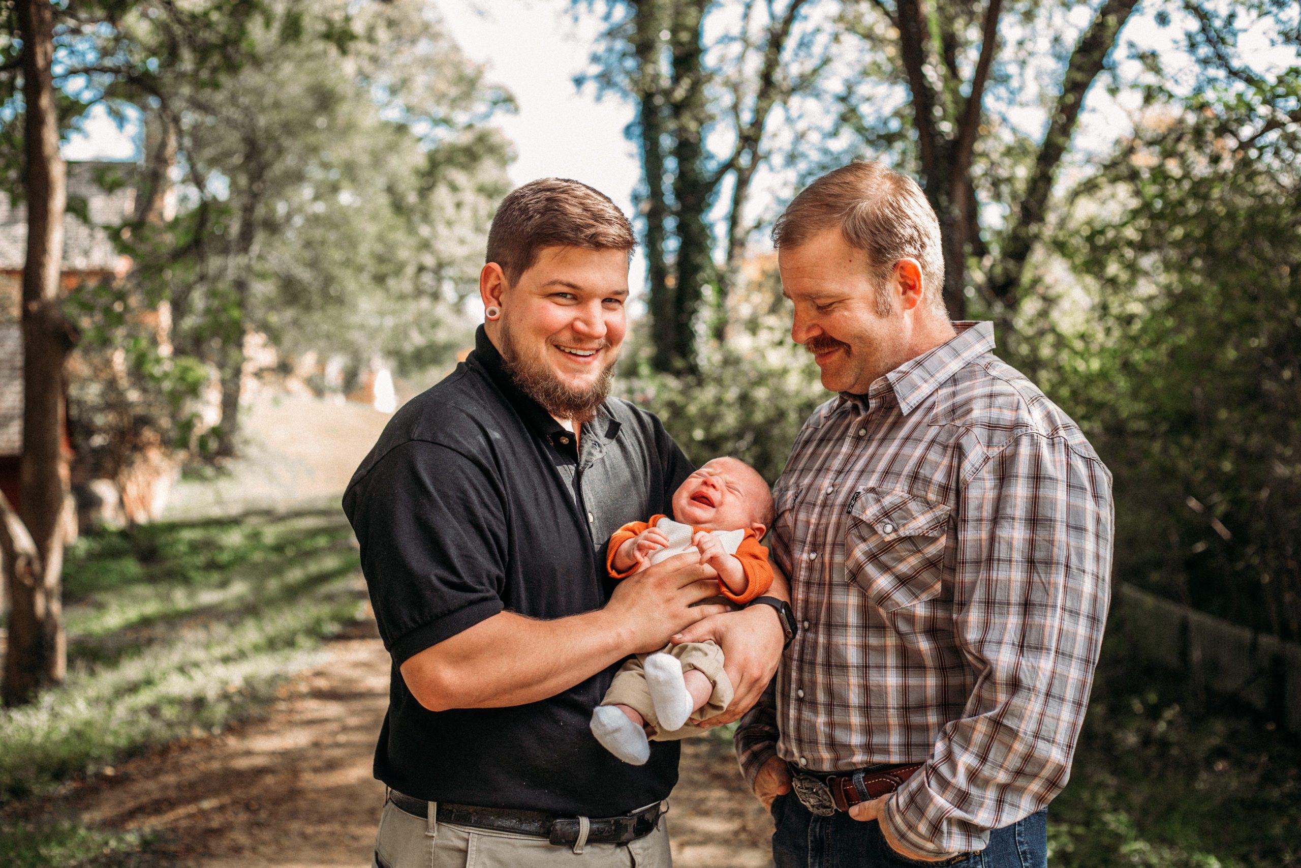 three generations of men together standing on a dirt path captured by best Hampton Roads family photographer