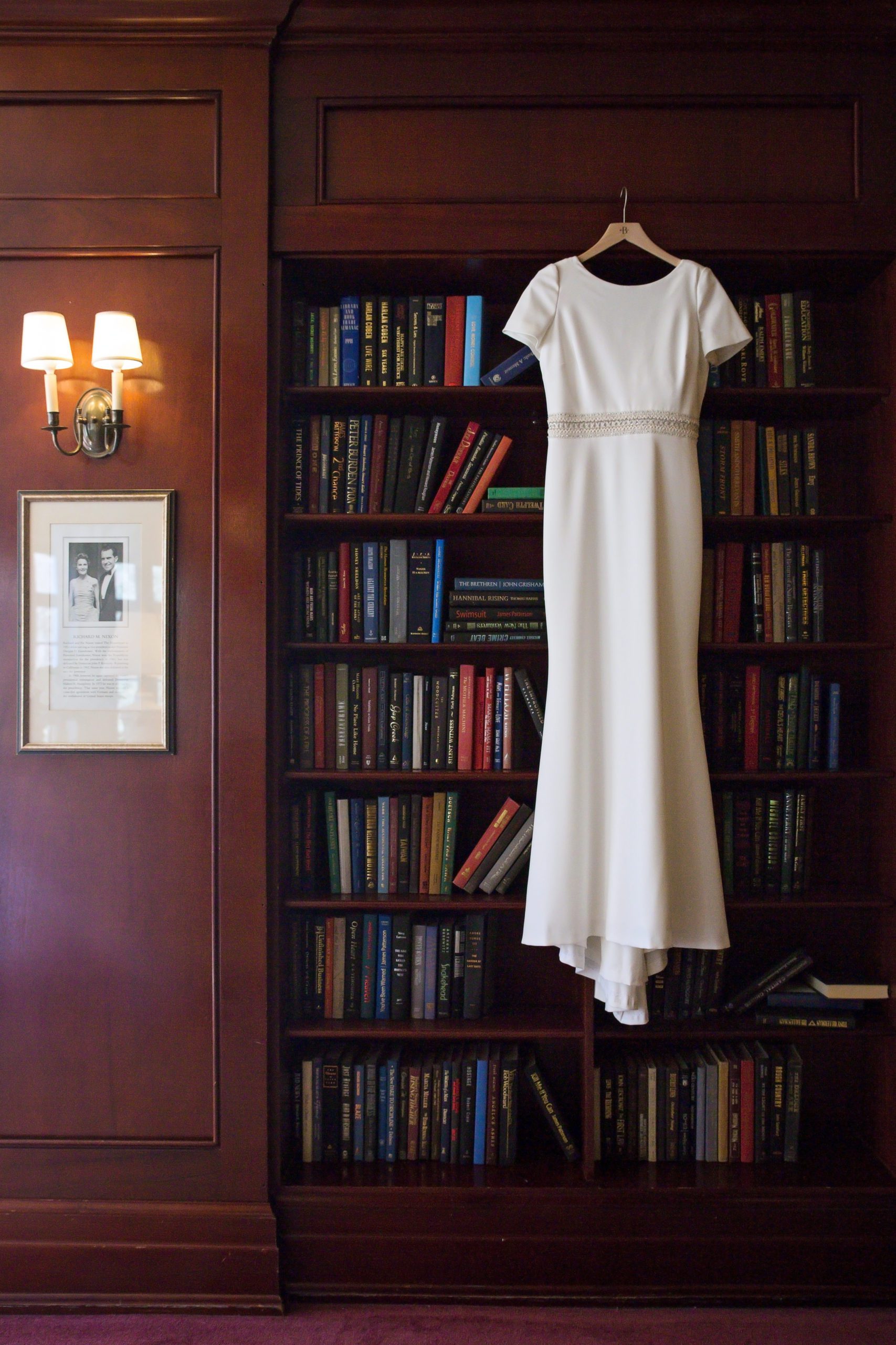 bridal gown hanging on a bookcase at Virginia wedding venue