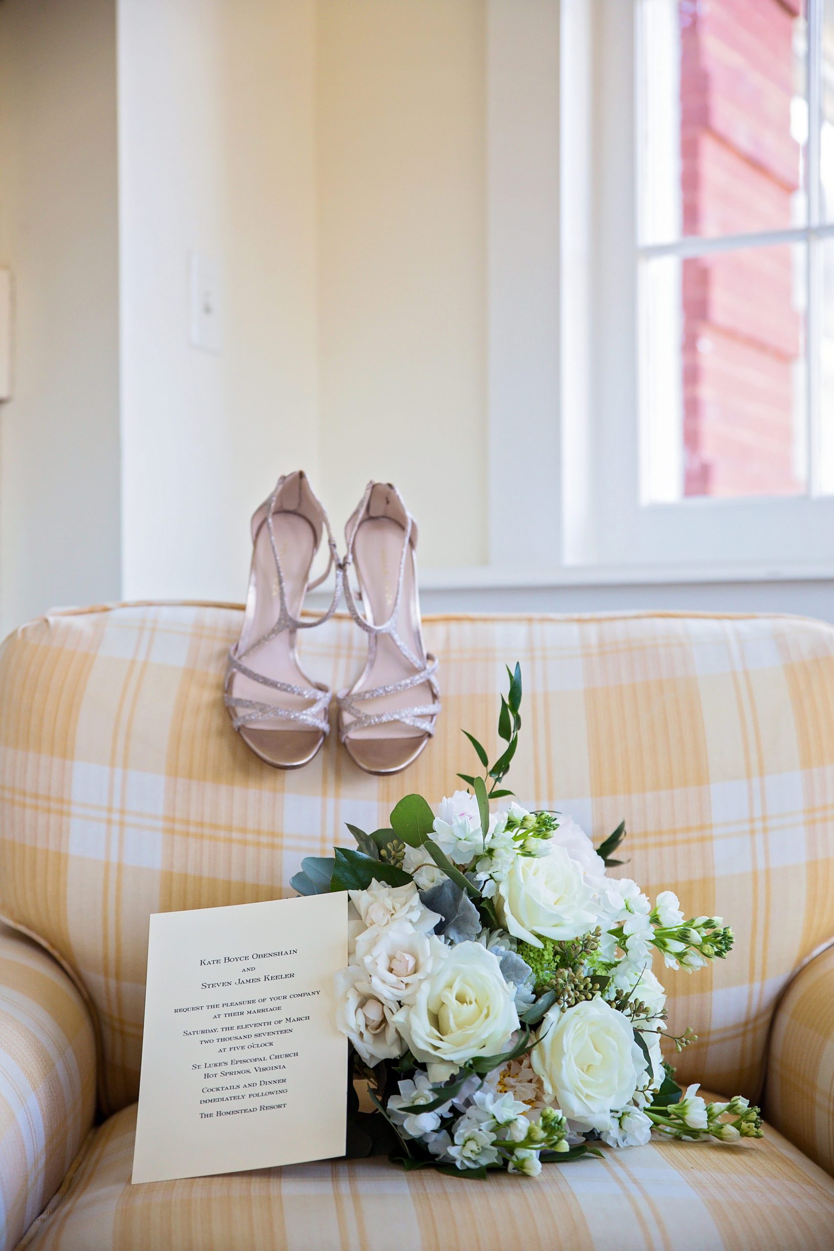 brides wedding shoes sitting on a yellow couch with her bouquet