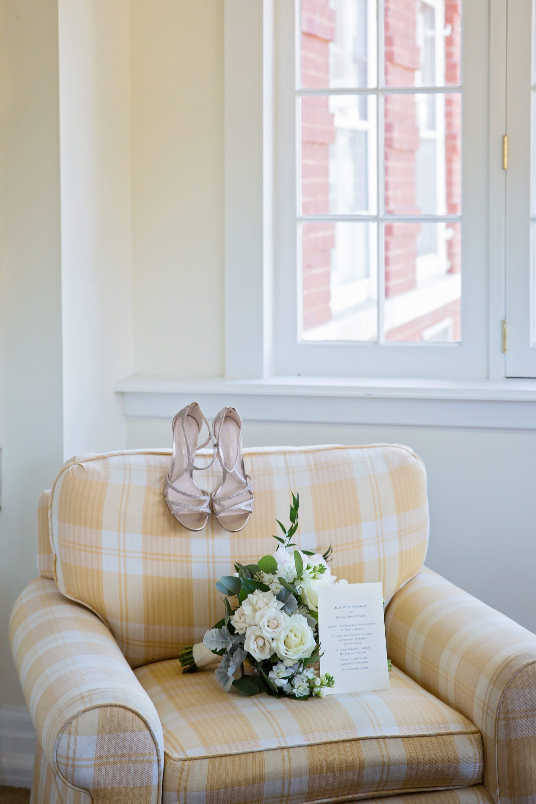 yellow and white plaid sofa with the brides wedding heels and bouquet moments while getting ready