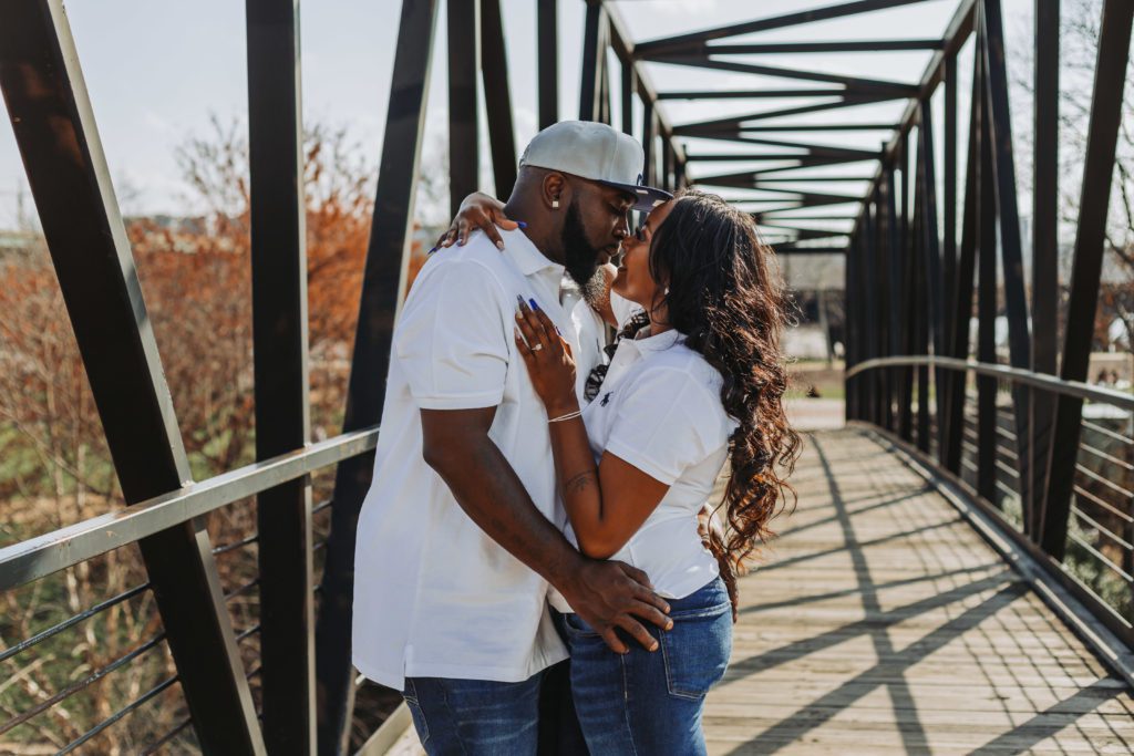 image of couple hugging each other on a bridge in richmond during their engagement session in one of the best places to propose in virginia 